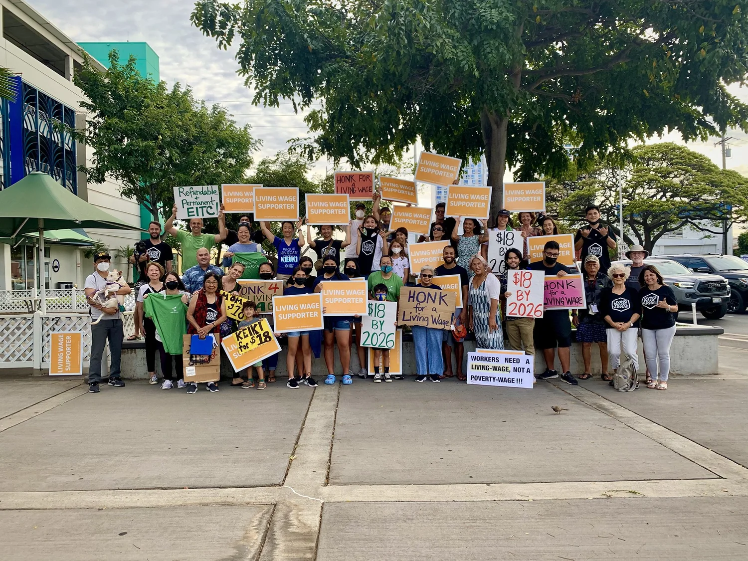 Hawaiʻi Appleseed staff, supporters, and coalition partners sign-wave in support of raising the state minimum wage and expanding the EITC in 2022.
